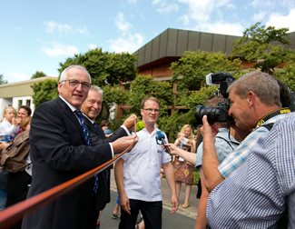 Members of the STAEDTLER top management holding the record-breaking Noris colour pencil in the finish area after it traveled 459.97meters around the STAEDTLER HQ.
